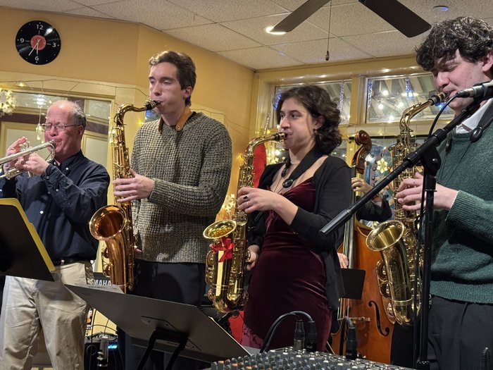 Musicians performing together at the December 2025 holiday gathering